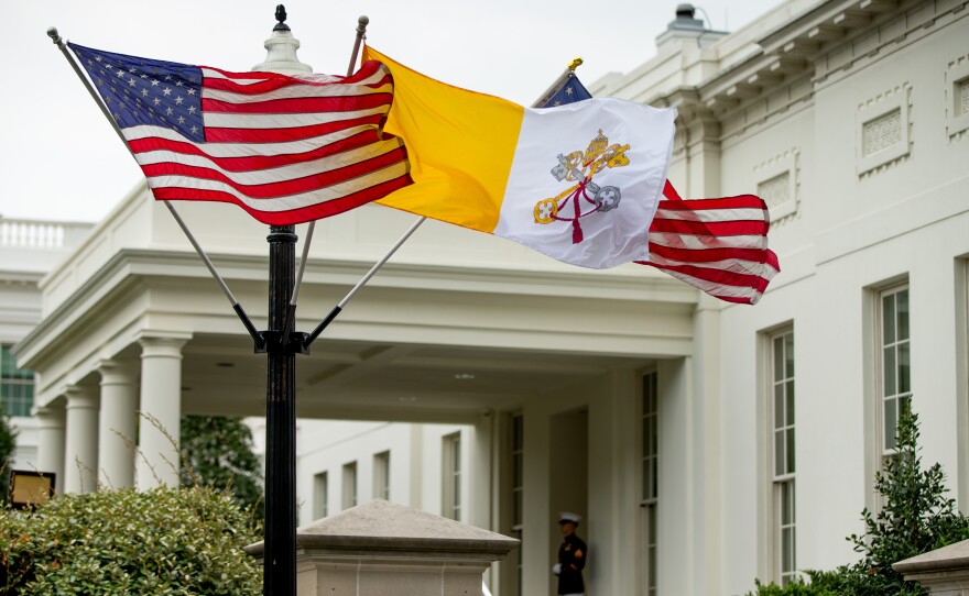 The Flag of Vatican City flies next to American flags outside of the West Wing of the White House on Monday ahead of Pope Francis' arrival.