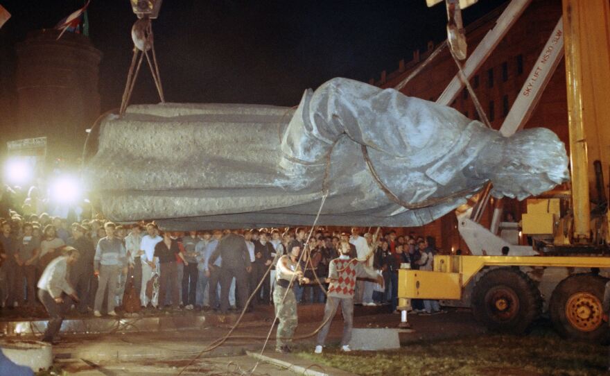 The U.S. isn't the only country where statues of controversial historical figures have been swept aside by protesters seeking a clean break with the past. Above, workers load a statue of KGB founder Felix Dzerzhinsky on a flatbed truck after it was toppled in Moscow on Aug. 23, 1991.