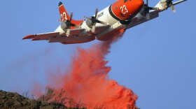 A firefighting air tanker drops fire retardant on the Tea Fire in Montecito, Calif. in 2008. In 2000, The U.S. Forest Service had contracts for 43 air tankers. These days, that number is only nine.