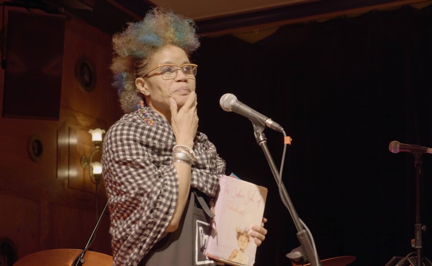 Staceyann reading from her latest book of poetry, "The Other Side of Paradise," to a captive audience.