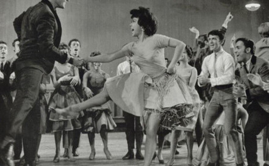 <p>George Chakiris (left) and Rita Moreno (center) play the couple Anita and Bernardo in 1961's <em>West Side Story.</em></p>
