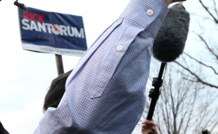 Reporters stick close to Republican presidential candidate Rick Santorum as he greets voters in Hollis, New Hampshire on Sunday.