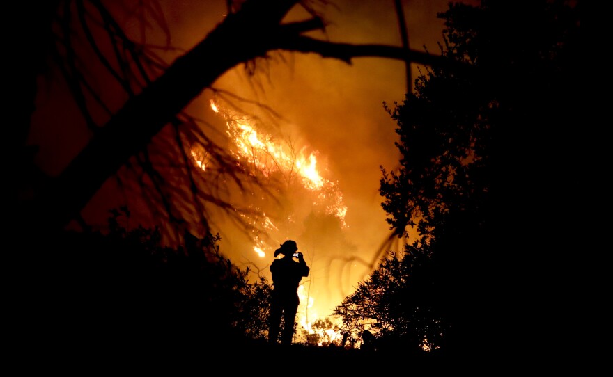 A firefighter snaps a quick picture amid efforts to contain the Thomas Fire in Montecito, Calif., earlier this month.