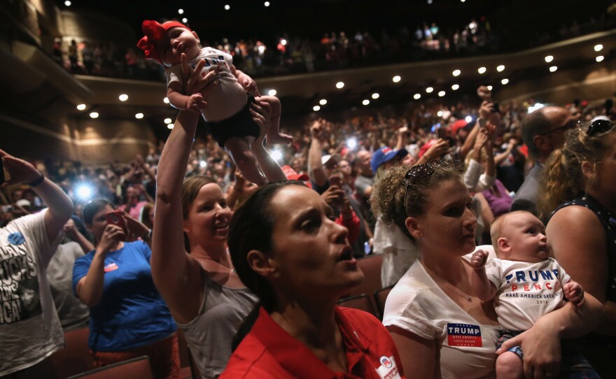 Women hold up their babies for Republican presidential nominee Donald Trump as he speaks at a campaign rally on Aug. 1 in Mechanicsburg, Pa.