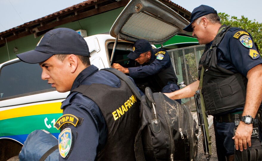 Officers and agents organize equipment as they get ready to launch the operation.
