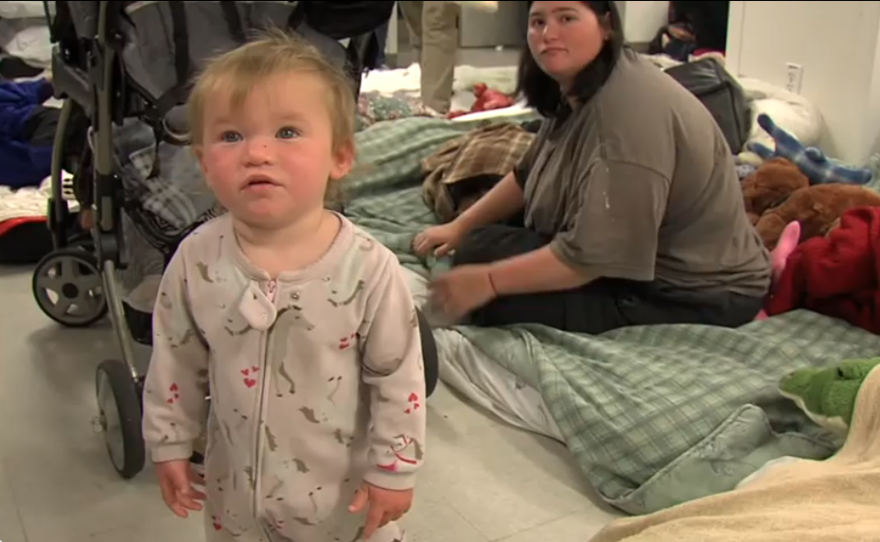 Baby Rebeka stands near her mother, Robin Gorman, at the Rescue Mission's emergency shelter for women and children, April 2013.