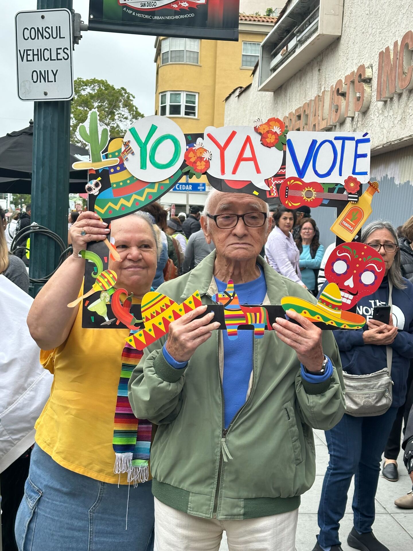 People hold up a sign that reads "Yo ya voté" ("I already voted" in English) on June 2, 2024, outside the Consulate General of Mexico in Little Italy, San Diego.