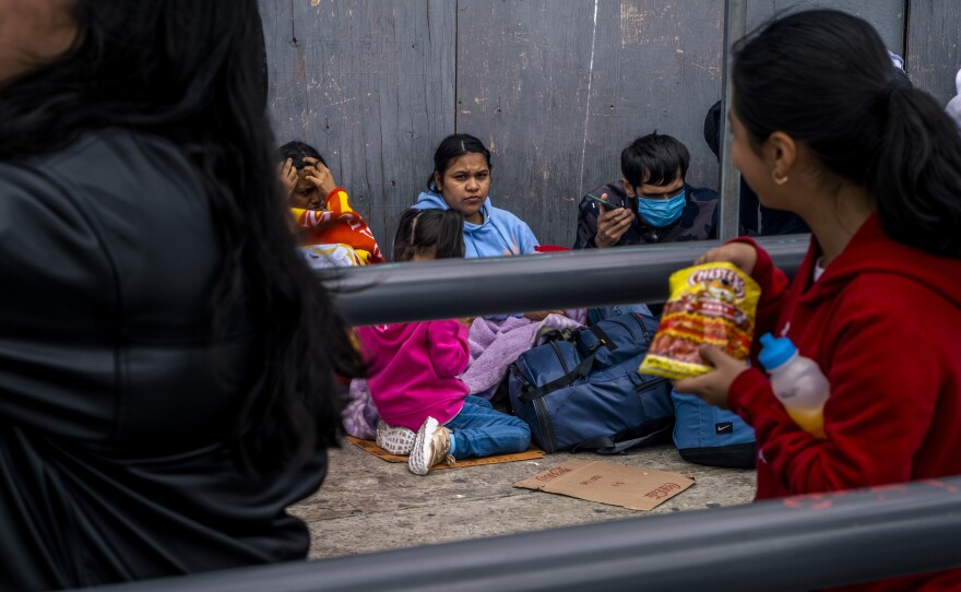 Families of asylum seekers sleep on concrete sidewalks outside the San Ysidro border crossing. On May 30, 2023, this family told reporters that they had spent three days living in the street while waiting for a chance to pursue humanitarian protection in the United States.