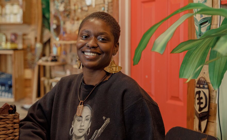 Isha Joseph at the front counter of clothing and jewelry store Make Manifest.