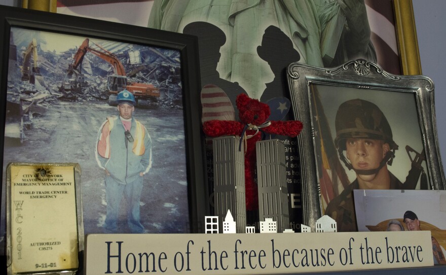 Framed photographs of John Feal (left) working as a first responder in the days before his injury at the World Trade Center, and during his time serving in the 101st Airborne Division.