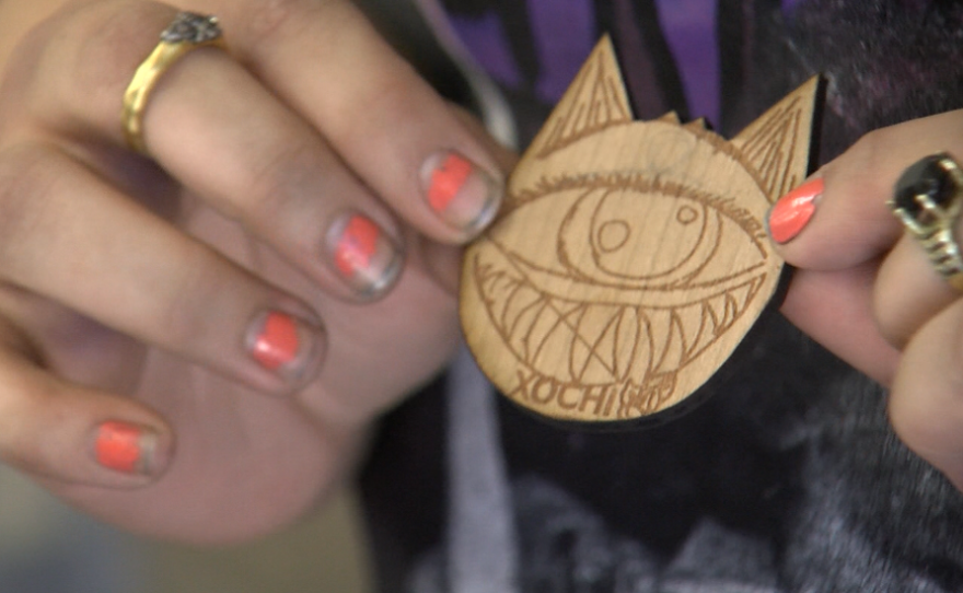 Skylar Pacheco-Rodriguez shows off an etching of a cat named Xochi, March 7, 2017.