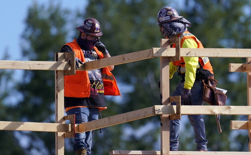 Construction workers are on the job in Simi Valley, Calif., earlier this week. Nationally, hiring resumed in January although the labor market still has a big hole to climb out of.