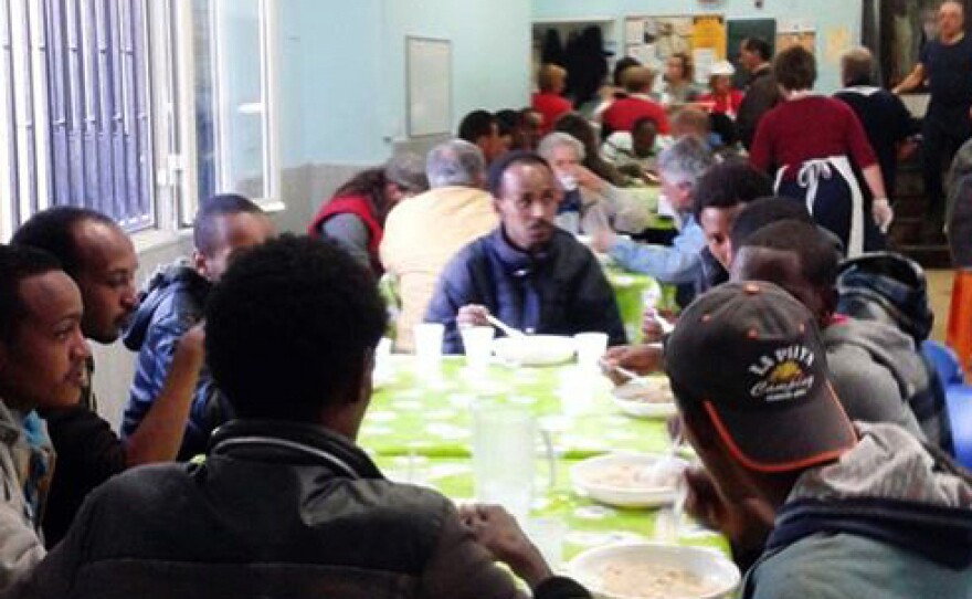 Hundreds of migrants have found support at the mess hall of the Caritas help center in Catania, where one volunteer says the crisis is pitting the poor against the poor, referring to homeless Italians and the newly arrived migrants.