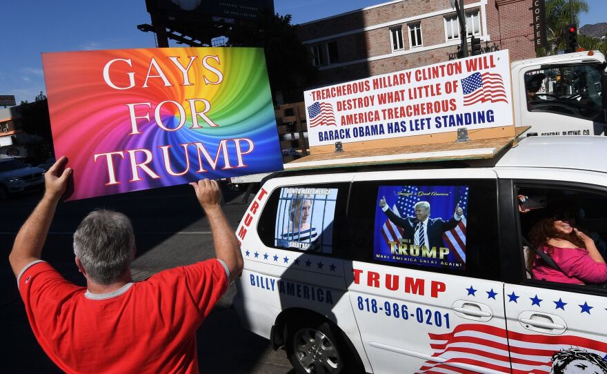 Supporters of Republican presidential hopeful Donald Trump, including gay rights groups, protest against alleged bias outside the CNN offices in Hollywood, California on Oct. 22, 2016.