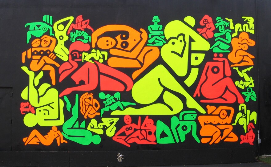 Ryan McGinness' 33 Women uses red, orange, green and yellow DayGlo paint on a black background.