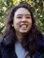 Woman with dark hair smiling at camera