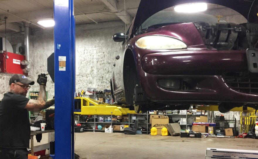 Nick Kuespert works the car lift at the Vehicles for Change shop in Baltimore.
