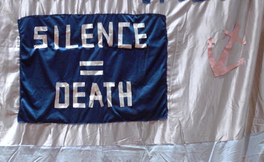 A part of the Memorial AIDS Quilt on display at UC San Diego reads "Silence equals death," Dec. 1, 2015.