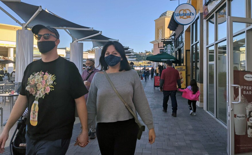 Shoppers wearing masks at the Fashion Valley Mall food court in this file photo from Nov. 28, 2020.