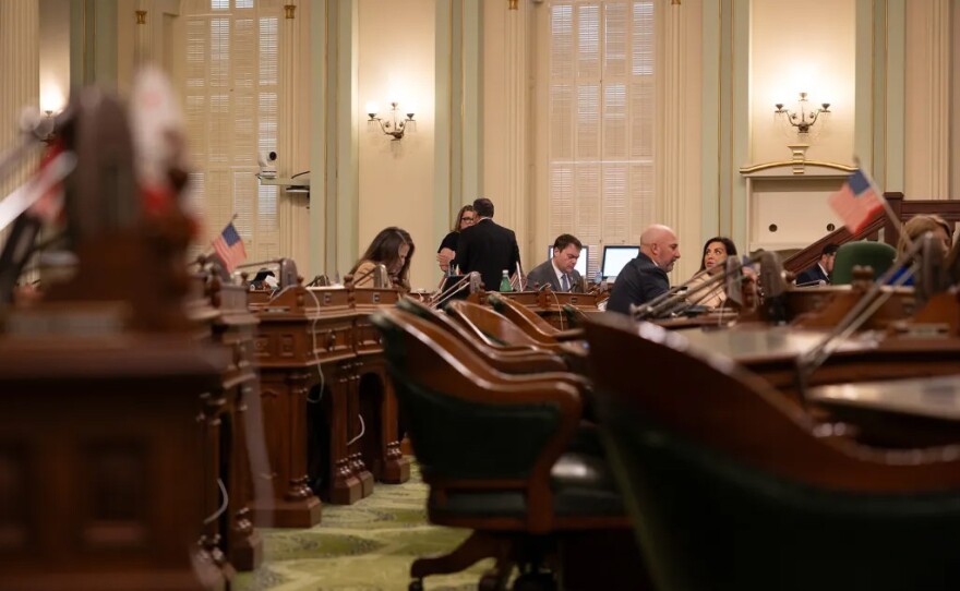 Lawmakers gather on the Assembly floor before the start of session at the state Capitol in Sacramento on June 30, 2025.