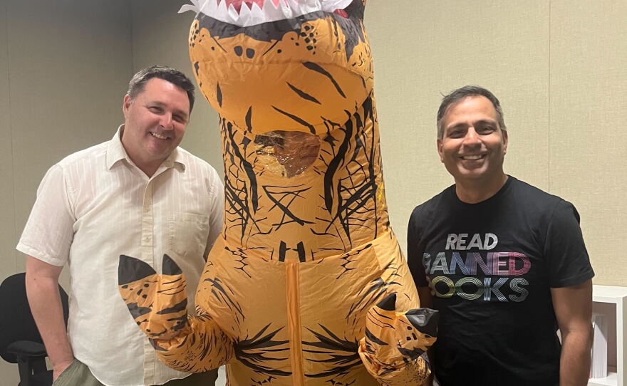 The Midday Movies tactical frivolity team of Andrew Bracken, Beth Accomando (in the T-Rex inflatable) and Movewallas' Yazdi Pithavala. Nov. 19, 2025.
