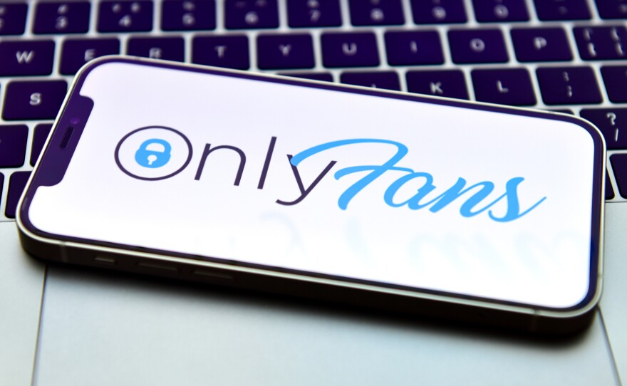In this photo illustration, an OnlyFans logo is displayed on a smartphone. OnlyFans says it will continue allowing adult content on its website.