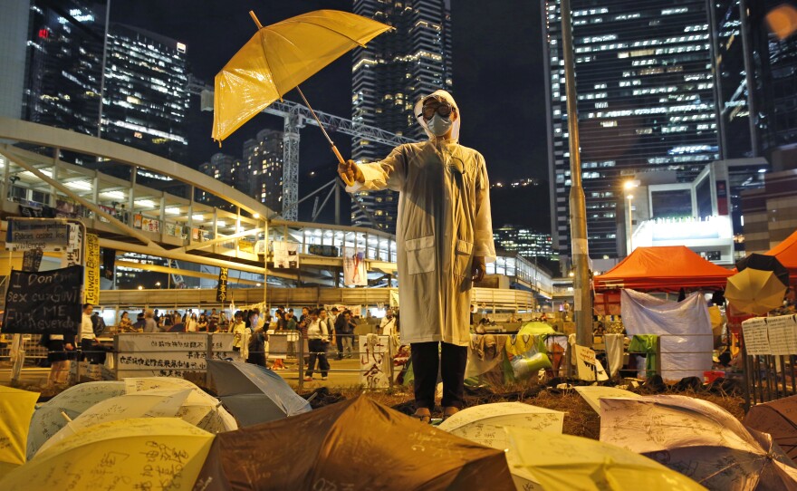 A Hong Kong protester holds an umbrella on Oct. 9, 2014, as part of the weeks of demonstrtions in the city two yeras ago. The protesters opposed the handling of the election for Hong Kong's chief executive, saying the three candidates were all hand-picked by Beijing.