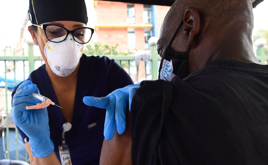 Nurse Christina Garibay administers Johnson & Johnson's COVID vaccine to a man at a community outreach event in Los Angeles in August.