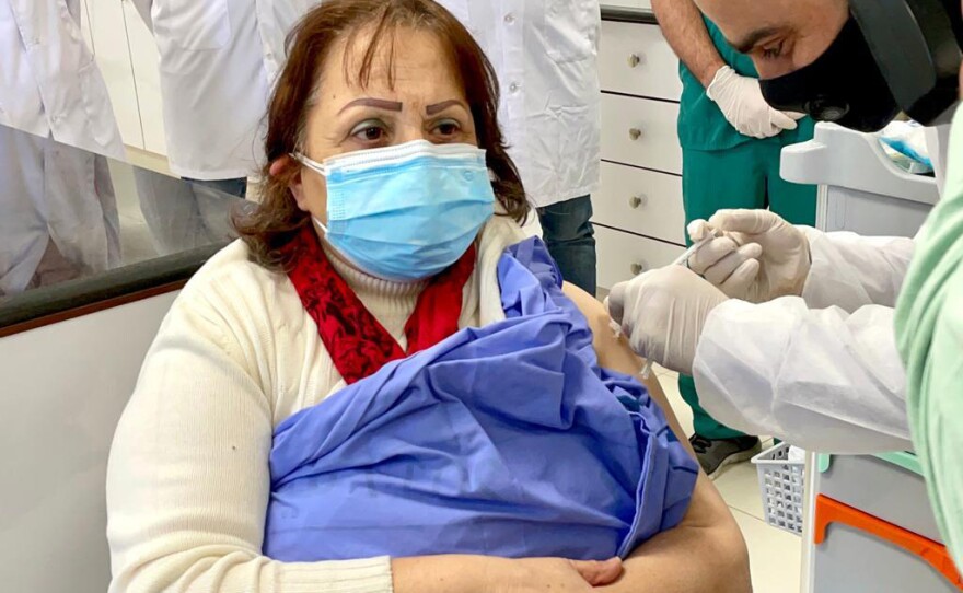 Palestinian Health Minister Mai al-Kaila receives a COVID-19 vaccination on Tuesday in a West Bank hospital.