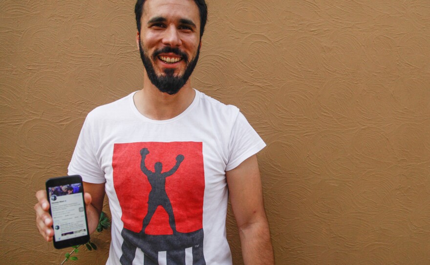 Lawyer Hassan Niazi, who represented Khadija Saddiqi, holds up his smart phone, which he used to run a social media campaign to create sympathy for his client.