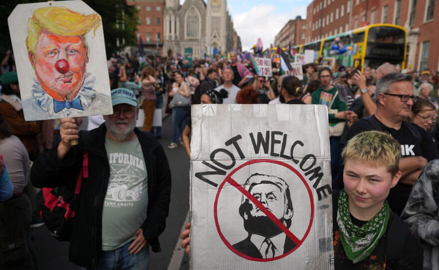 Protesters show placards during a demonstration against the visit of U.S. President Donald Trump in Dublin, Saturday, Sept. 12, 2026.