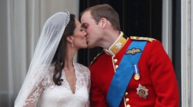 Their Royal Highnesses Prince William, Duke of Cambridge and Catherine, Duchess of Cambridge kiss on the balcony at Buckingham Palace after their wedding.