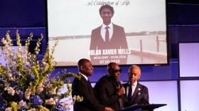 Elmore Wonsley, center, speaks next to attorney Ben Crump, left, and Rev. Al Sharpton during a memorial service for Nolan Xavier Wells on Monday.