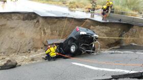 In this photo provided by the Cal Fire/Riverside County Fire Department, emergency crews respond after a pickup truck crashed into the collapse of an elevated section of Interstate 10 in Desert Center, July 19, 2015.