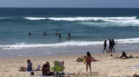 Beachgoers play in the ocean at Mission Beach, May 1, 2016.