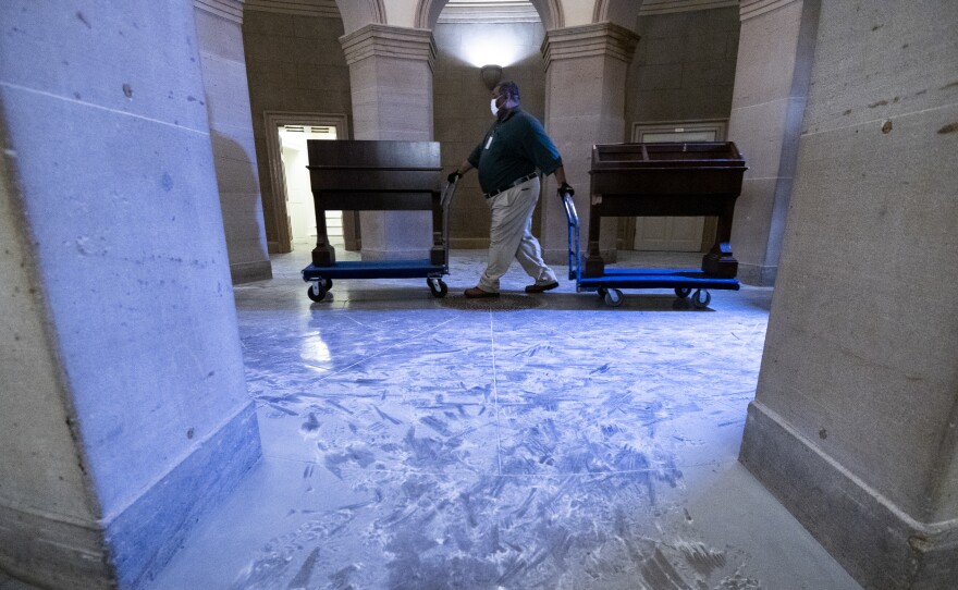 Capitol workers remove damaged furniture on from the U.S. Capitol on January 7, 2021, following the riot at the Capitol the day before.