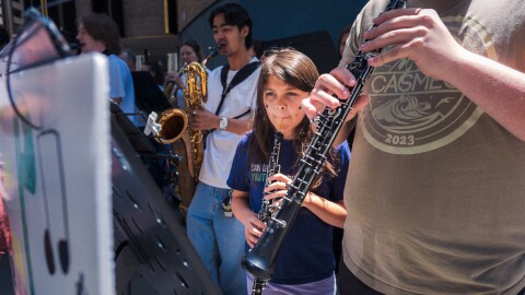 Protesters opposed to San Diego Mayor Todd Gloria's budget cuts to arts programs gather at San Diego's Civic Center Plaza before a City Council meeting on April 20, 2026.