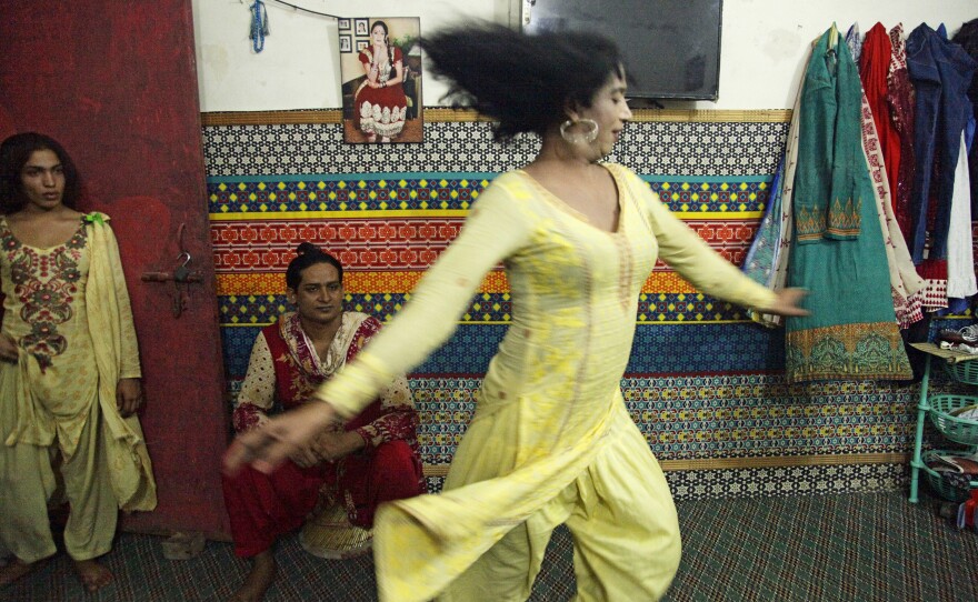 Transgender women dance for visitors in an apartment where they live together in Lahore.