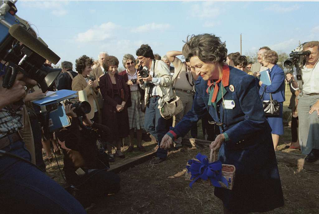 Lady Bird Johnson spreads seeds during a groundbreaking at the new National Wildflower Research Center in December 1982.