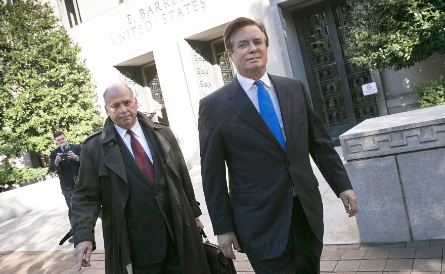 Former Trump campaign chairman Paul Manafort (right) leaves District Court after pleading not guilty following his indictment on federal charges Monday.