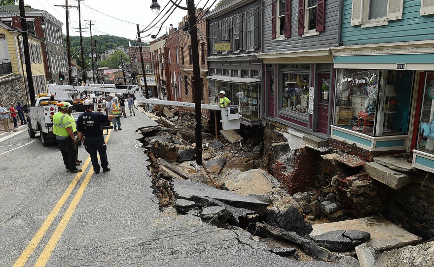 Rescue workers on Sunday look at the destruction caused by a flash flood on Main Street in Ellicott City, Md.