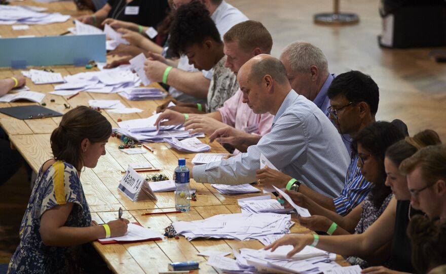 Vote-counting staff sort ballots at The Royal Horticultural Halls in central London on Thursday. The referendum was held on paper ballots, counted by hand.