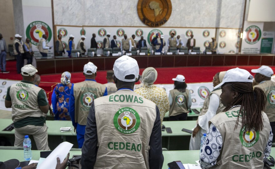 Members stand for the arrival of dignitaries at a joint press conference by African Union (AU) and Economic Community of West African States (ECOWAS) electoral observers in Abuja, Nigeria