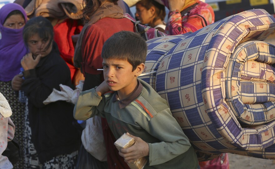 Thousands of Syrians enter Turkey at Yumurtalik crossing gate near Suruc, on Tuesday. UNHCR has warned of a growing refugee crisis.