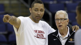 San Diego State assistant coach Tony Bland, left, talks with head coach Steve Fisher during practice Thursday, March 15, 2012, in Columbus, Ohio. 