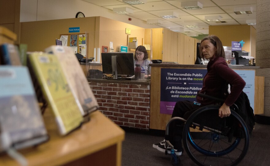 A woman looks around the Escondido Public Library, Apr. 23, 2025.