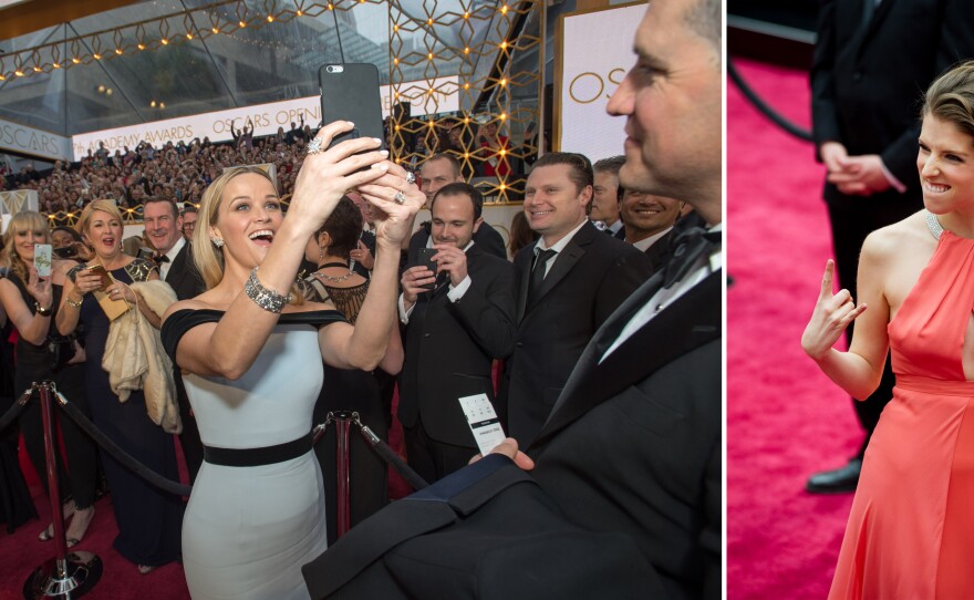 Selfies on the red carpet were popular, here's Best Actress nominee Reese Witherspoon taking one; and Anna Kendricks, who performed the Oscar opening number, has fun with the bleacher crowd at the 87th annual Academy Awards, Feb. 22, 2015.