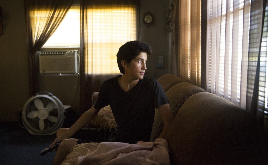 Angel waits for his father to get home from work.