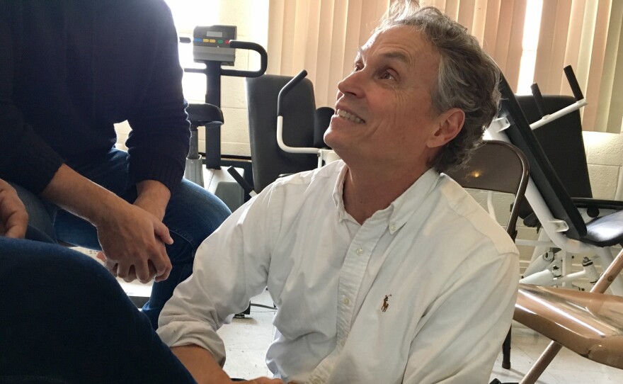 Dr. Bert Johansson, an El Paso pediatrician, treats lesions on a migrant man's foot at a makeshift clinic within a local shelter.