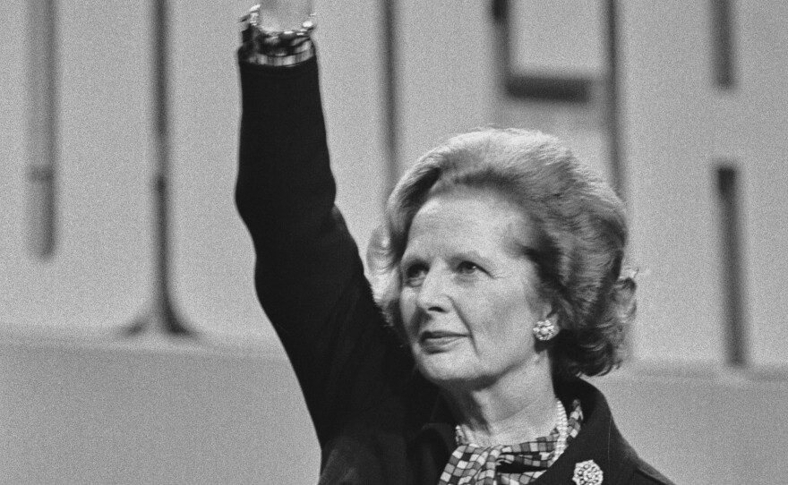 British Prime Minister Margaret Thatcher waves from the podium at the Conservative Party Conference in Brighton in October 1984.